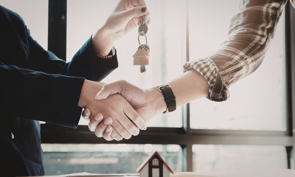 Handing over house keys to new owner