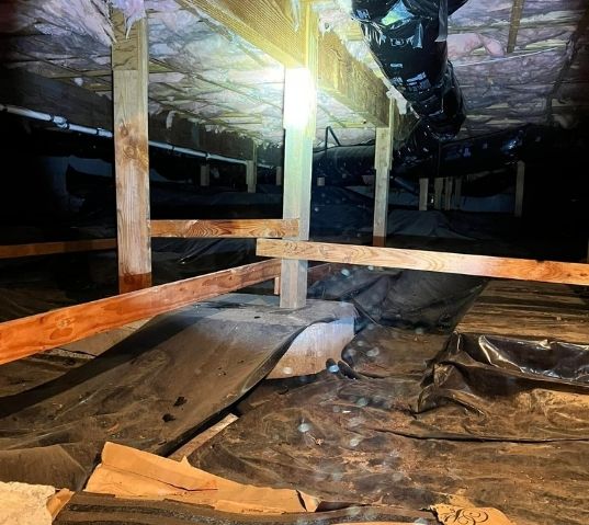residential crawl space undergoing structural repair to address moisture and support issues
